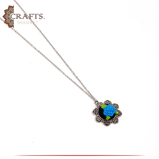 Silver Metal Necklace with a Hand-embroidered Pendant Blue Rose design. Silver Metal Necklace with a Hand-embroidered Pendant Blue Rose design.