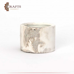 Candle holder with a white candle tinged with brown