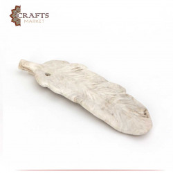 A short, white leaf with brown tinges