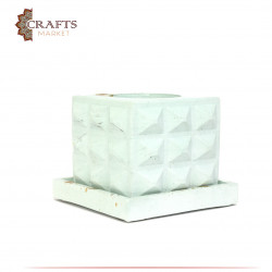 A square cement bowl with raised ridges