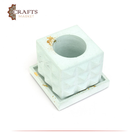 A square cement bowl with raised ridges A square cement bowl with raised ridges